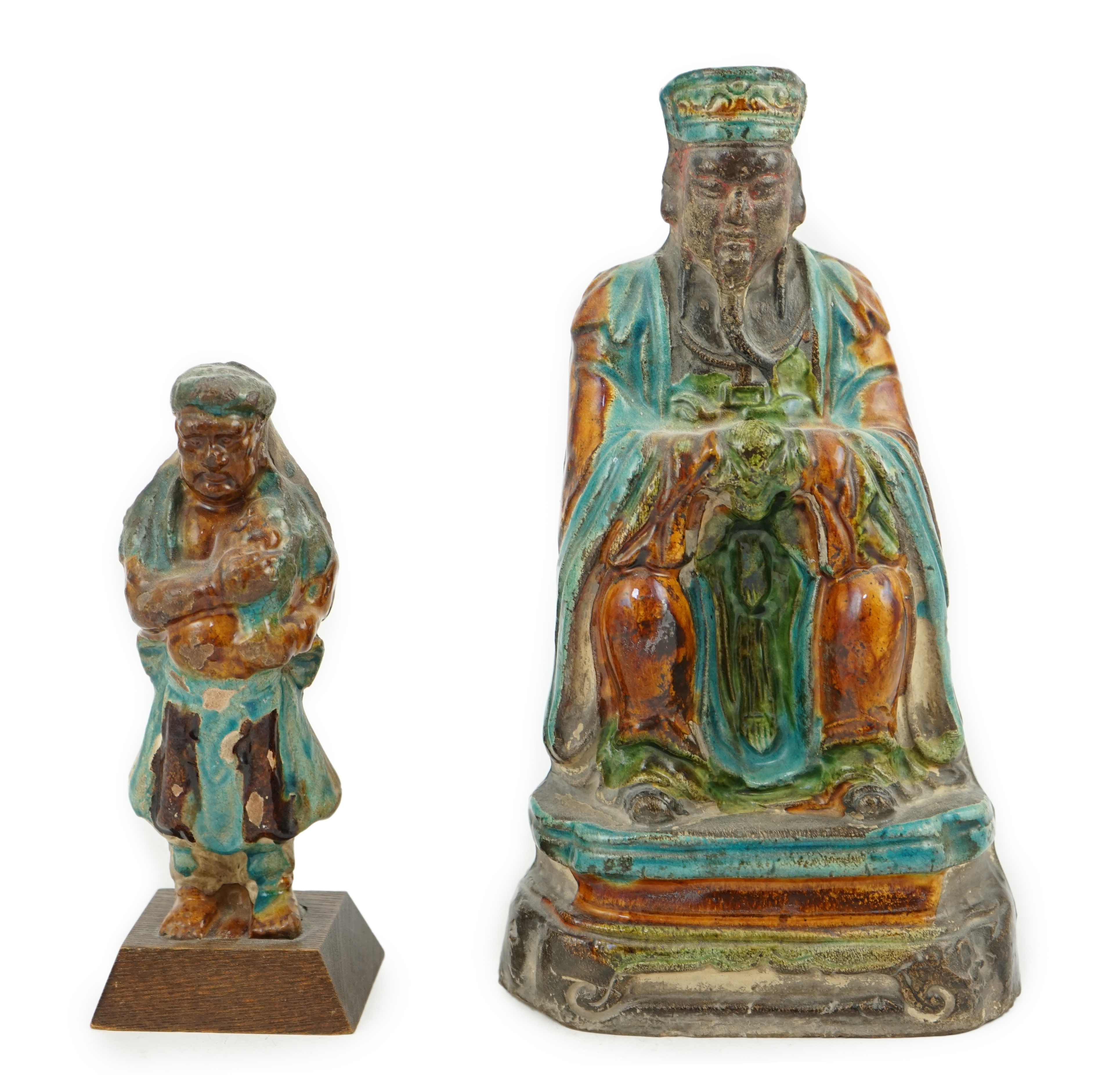 Two Chinese sancai glazed figures of a seated dignitary and a standing attendant, Ming dynasty